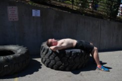 Sam Stewart, 1st year Applied Systems Networking Administration major at RIT, takes a nap while waiting to compete in the 6th Annual Strongman Competition during Imagine RIT 2013 at Rochester Institute of Technology in Henrietta, N.Y. on Saturday, May 4, 2013. "It's a lot harder than I thought it would be" said Stewart after 6 hours of competition. (Josh Barber)