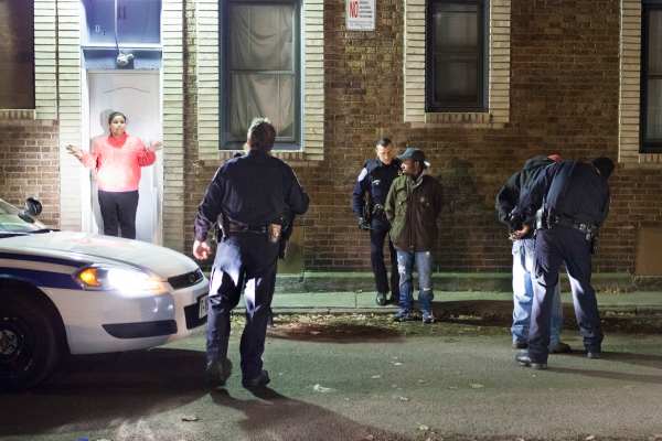 A young woman outside her home reacts to Lieutenant Eric Paul and his officers arresting two men suspected of carrying a weapon on Nov. 19, 2013, in Rochester, N.Y. The two individuals were released immediately after it was determined that they were not who the police were looking for. Photo by Rugile Kaladyte