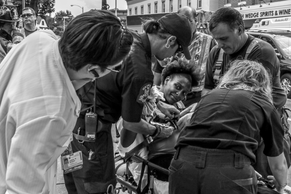 Pregnant woman involved in a four-car accident on South Avenue, Rochester, NY on July 31, 2013. Paramedics secure her to a stretcher. Photo by Zack DeClerk